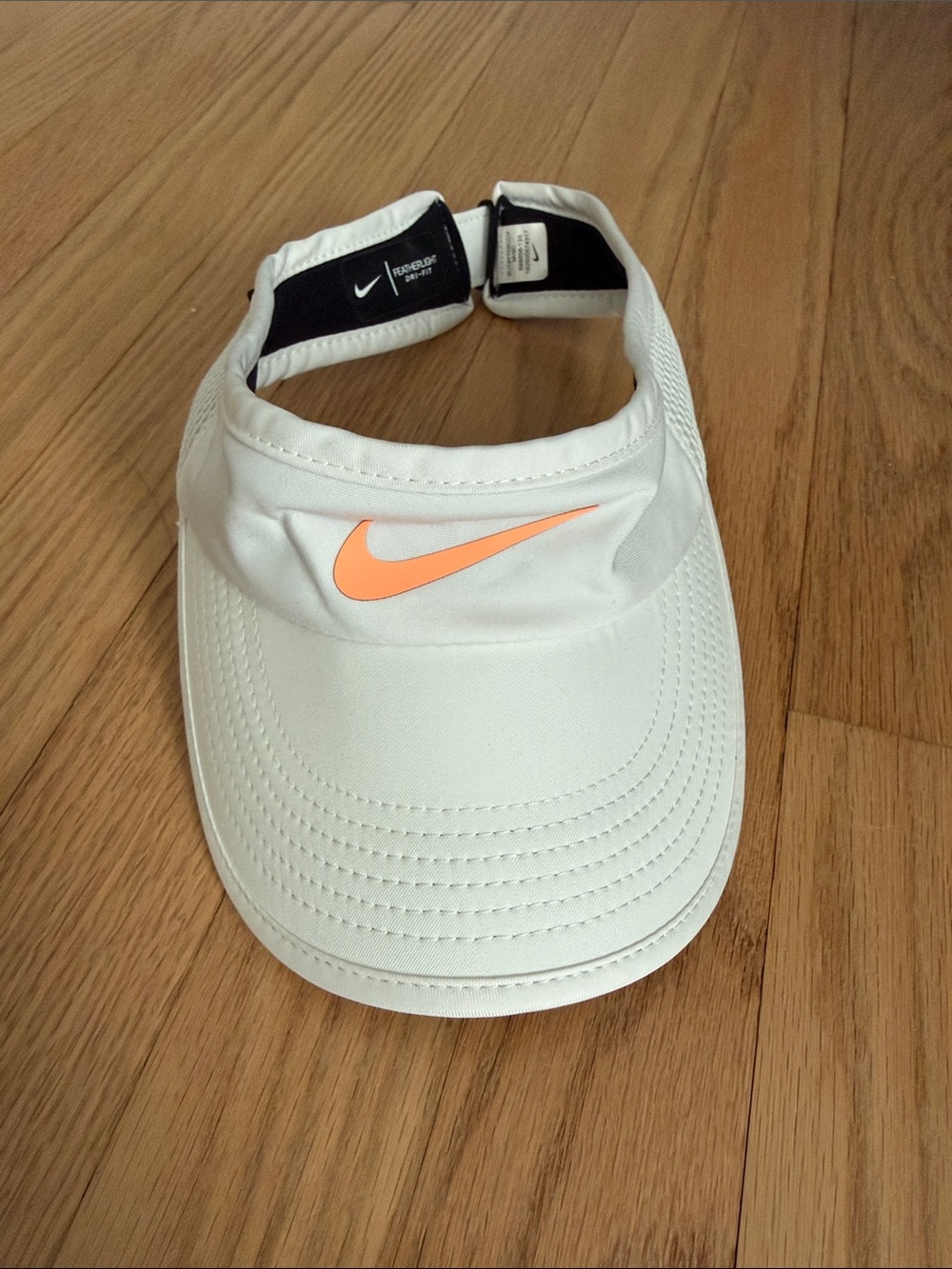 Nike Women's White Visor with Peach-Orange Swoosh - OS